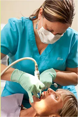 Hygienist performing dental cleaning